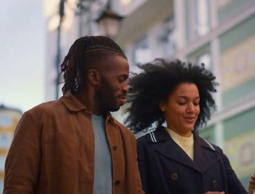 a couple walking down a city street